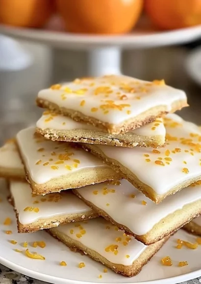Delicious cardamom shortbread cookies with orange glaze on a plate