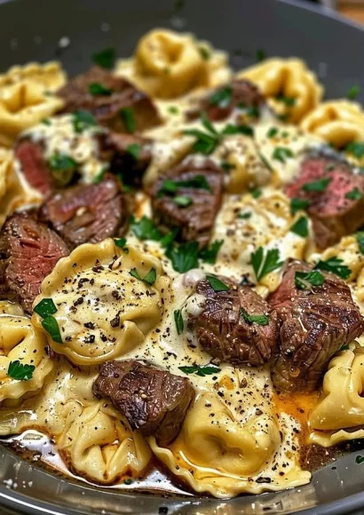 Cheesesteak tortellini served in rich provolone sauce with garnishes