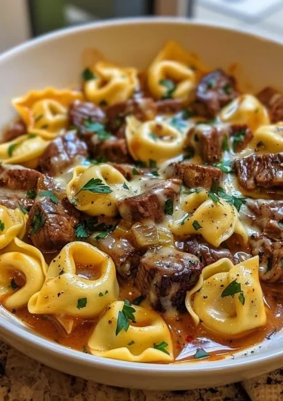 Cheesesteak Tortellini in Provolone Sauce served in a bowl