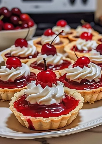 Delicious Cherry Delight Tarts topped with fresh cherries and whipped cream