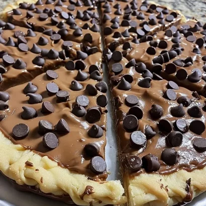 Chocolate chip cookie dough pizza slice with drizzled chocolate