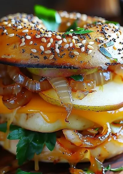 Pear apple cheddar caramelized onion grilled cheese bagel sandwich