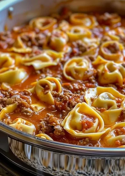 Slow Cooker Cheesy Tortellini in a bowl with melted cheese and herbs