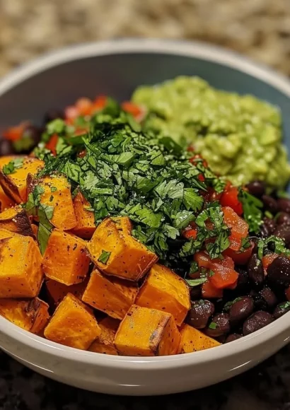 Sweet potato and black bean bowls topped with avocado lime dressing